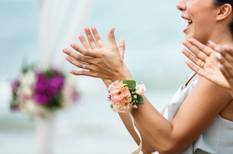 Womens in corsages clap happily