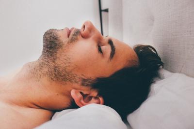 A man sleeping after reading a Doctor's Guide to Sleep Solutions for Stress and Anxiety