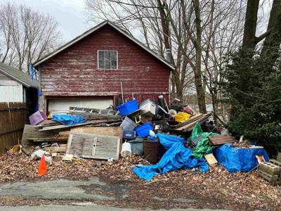 a house with a lot of junk in front Phoenix Junk Removal