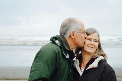 Aging man and woman with life insurance relax at the beach