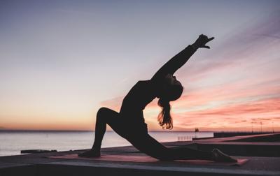 Woman does yoga to relax and unwind from stress