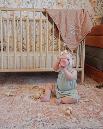 Baby sits on a washable rug in case she spills or makes a mess