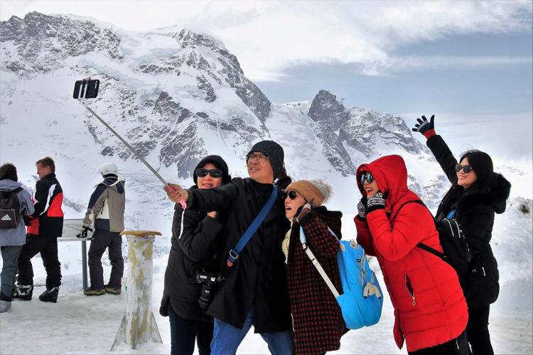 Tourists crowd in for a selfie during transformative journey