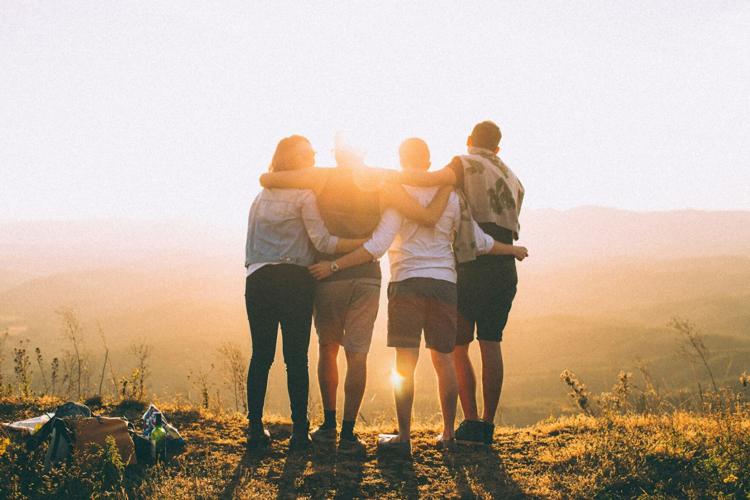 Four friends hug each other, having mastered the art of connection