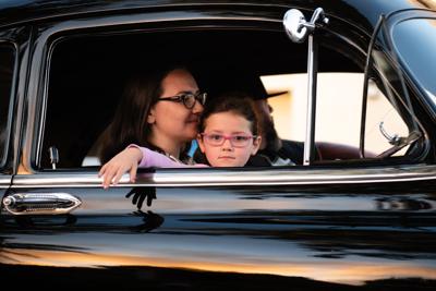 Mother and child sit in their leased family car