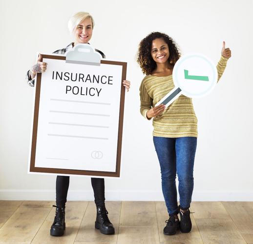 People hold up their insurance policy to indicate that you need to review it
