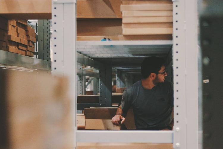 Man considers optimal storage solutions in his storage area
