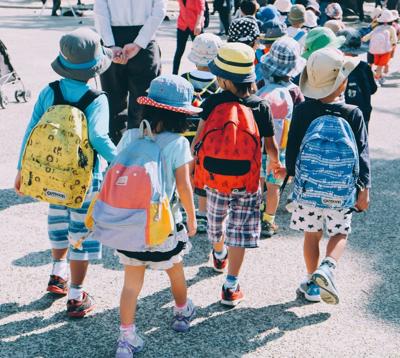 Children walk around outside at their Austin school