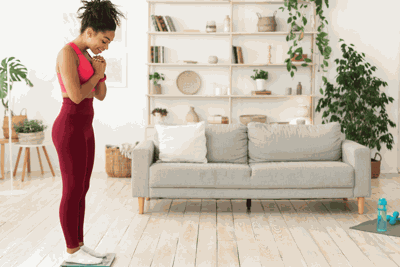 Woman stands on scale during her personalized weight loss journey