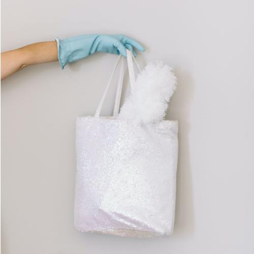 A White Bag of Must-have Cleaning Products To Properly Deep Clean Your House