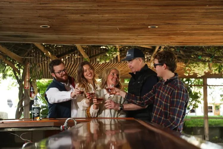 Jason Wooler with wife Amy and their children raising glasses together for Wooler Brands