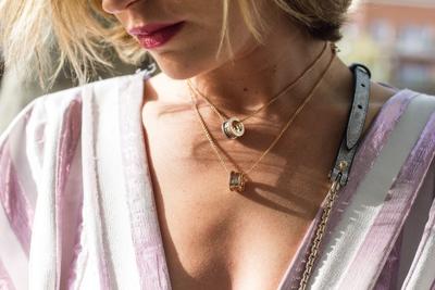 Woman wearing layered necklaces to express her style