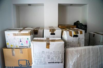 Boxes piled in corner after being packed on moving day