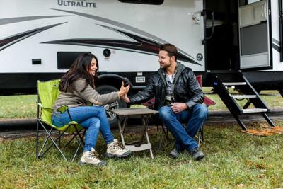 a couple sitting at an Amazing  RV Spot Camping in California