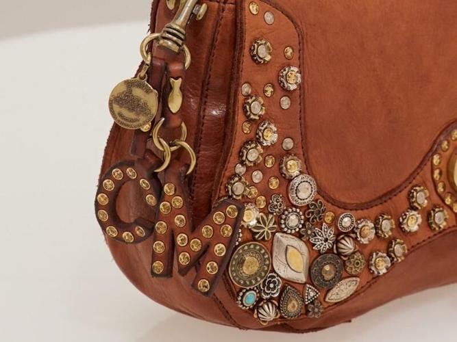 Leather bag with decorative pieces can complement your style in every season