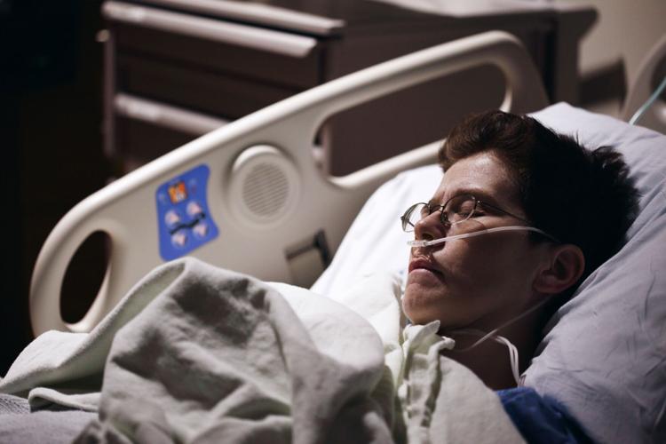 Man lies in hospital bed while receiving care chosen by loved ones