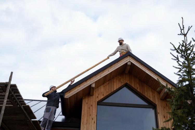 Men work on a roof to make sure it is in good shape