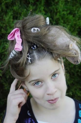 Girl with a rats nest hairdo poses for the camera