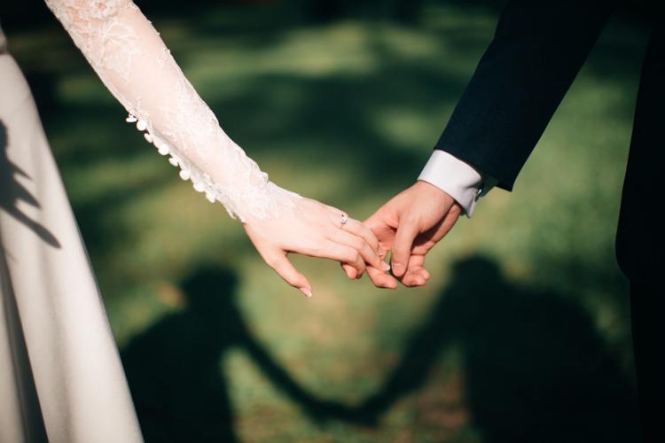 Bridge and groom hold hands during their wedding in Mexico