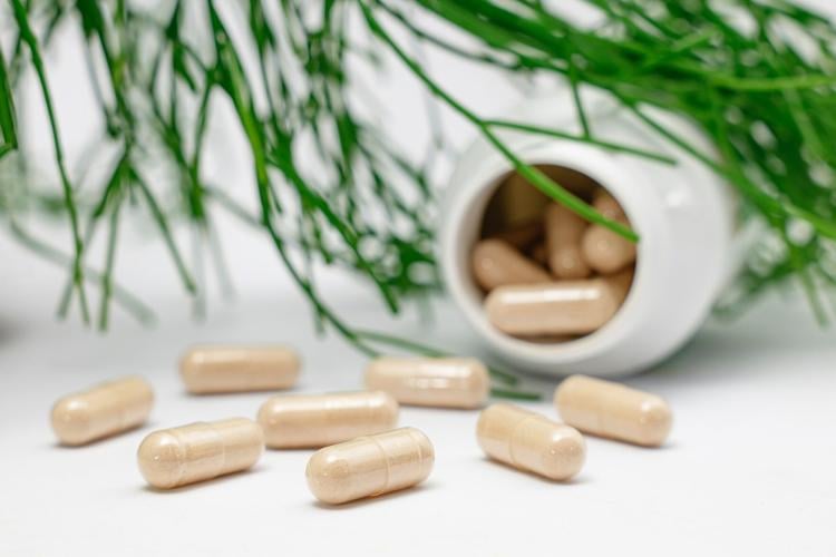 BPC 157 supplement capsules spill out of bottle