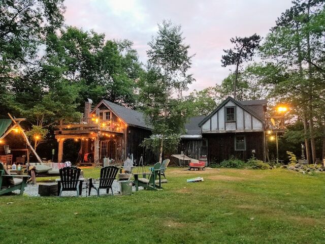 A beautiful outdoor lawn and firepit space provides refuge from the busy world