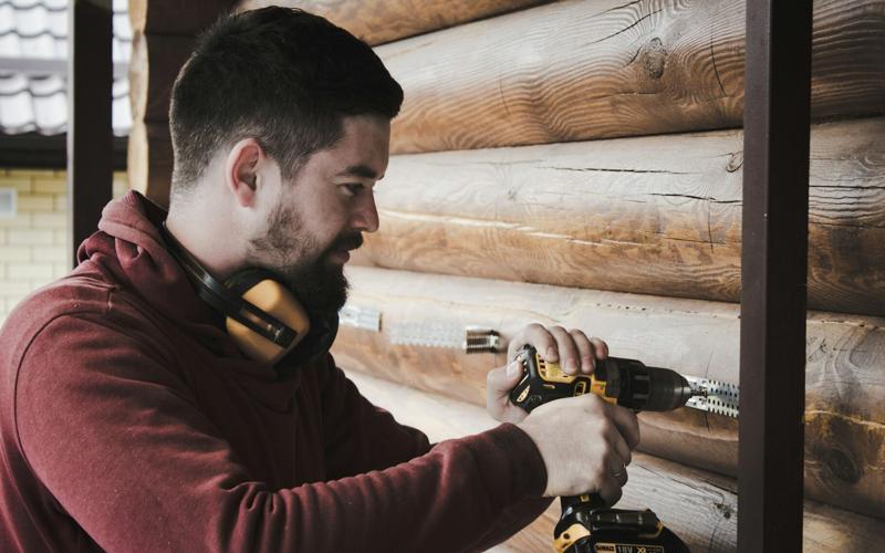 Man uses power tool while improving his house
