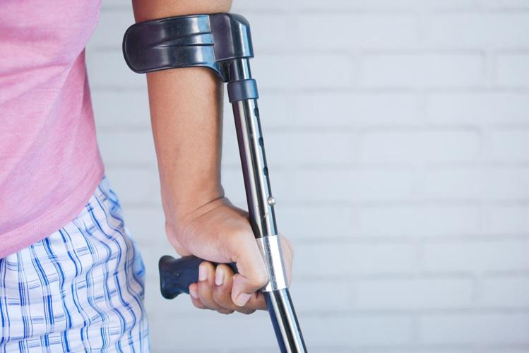 Person uses cane as they advocate for their own health