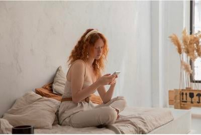 Redhead on bed in a Garment Designed For Daily Use