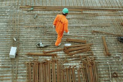 Construction worker walks around construction site