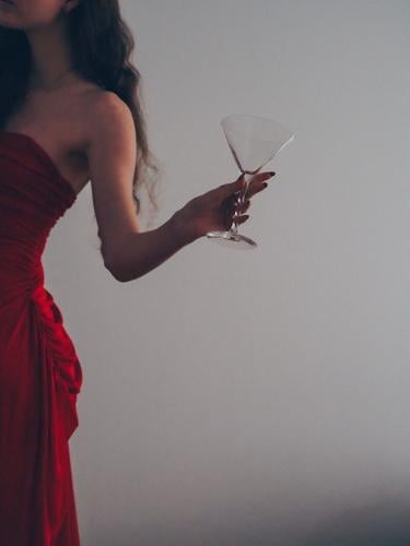 Woman in red dress attends extraordinary luxury party