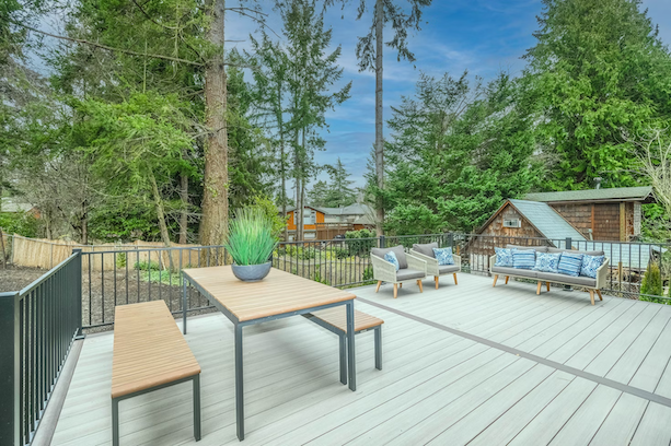 A large deck with beautifully maintained furniture and wood planks