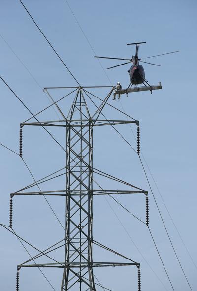 High wire act: Crews working to make midair repairs to ...