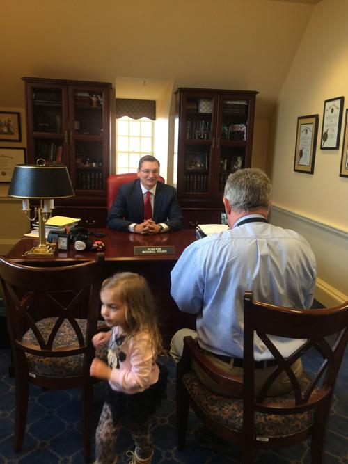 Senator Hough sits for portrait as daughter looks on