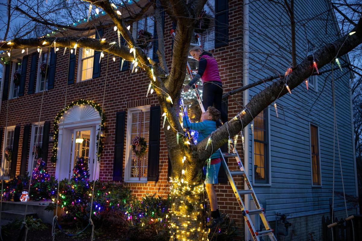 It's dark outside. Families are putting up Christmas lights early to
