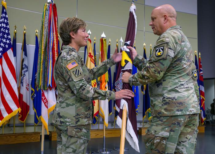 Major Gen. Paula Lodi, left, receives the command flag from Lt. Gen. Ross Coffman during a Change of Command ceremony for the U.S. Army Medical Research and Development Command at the Fort Detrick auditorium on Wednesday. Photo by Ric Dugan