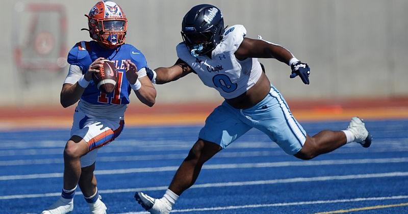 Cesar Huerta (11), quarterback for the Canutillo Eagles, evades Malachi Garcia (9) of the Chapin Huskies before completing a pass and advancing the ball during a high school football game Saturday at Canutillo High School. Oct 24, in El Paso, Texas.