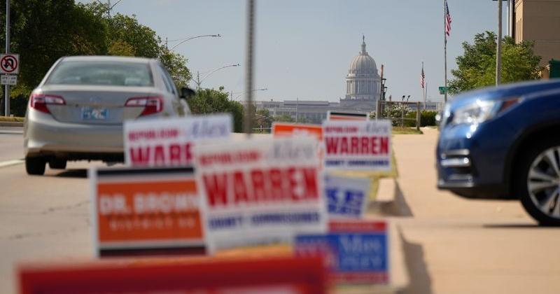 Signs line Lincoln Boulevard in front of the Oklahoma County Election Board during the first day of early voting for the August 25 runoff elections and state questions, Thursday, Aug. 20, 2026.