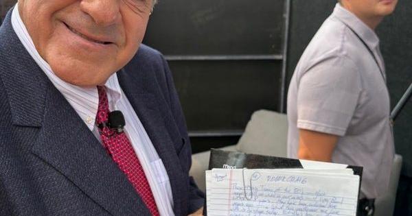 Chris Berman, who served as master of ceremonies for the Pro Football Hall of Fame induction ceremony for the 26th time, shows off his hand-written scripts on Saturday, Aug. 8, in Canton, Ohio.