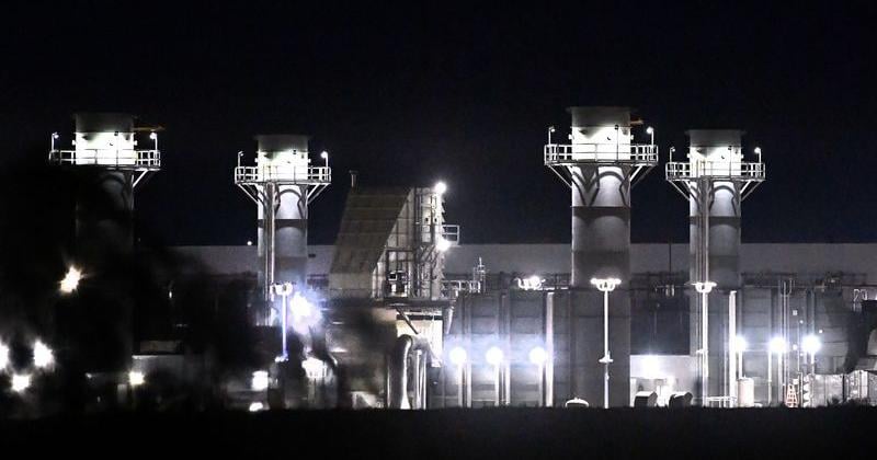 Gas turbine towers are lit outside the Abilene DC1 Stargate Project data center April 21.