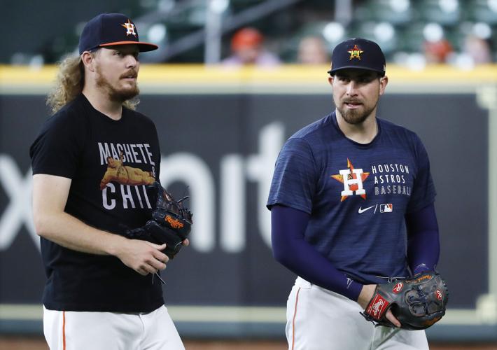 Houston Astros' Michael Brantley, right, celebrates with third base coach  Omar Lopez (22) after hitting a three-run home run against the Chicago  White Sox during the first inning of a baseball game