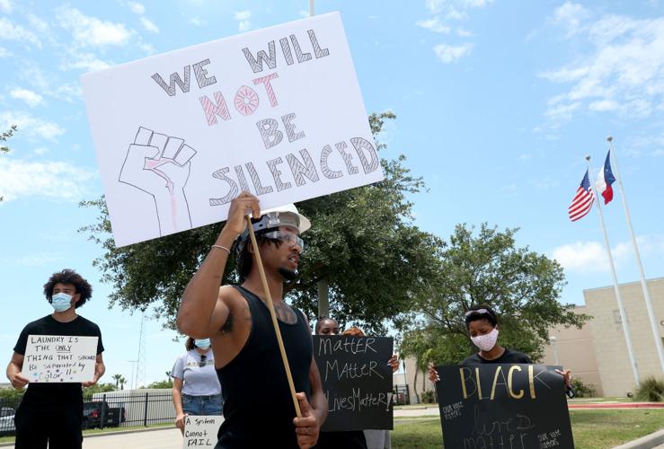 Protestors gather outside Galveston Police Department to talk about