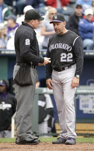 Third base umpire Dan Bellino left talks with Colorado Rockies Mike  Moustakas