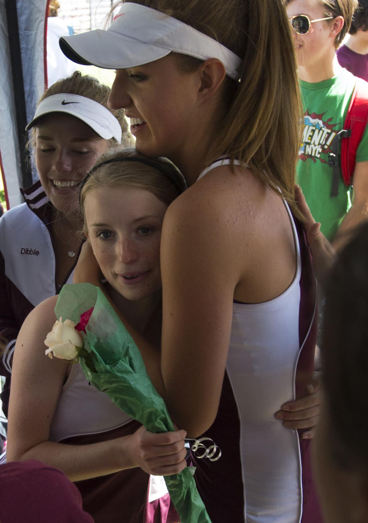 Cheyenne Mountain's Kalyssa Hall, right, hugs Megan Dibble as they wait for the award ceremony to start Saturday, May 10, 2014, at the Colorado 4A girls state tennis championships finals at City Park in Pueblo. (The Gazette, Christian Murdock)