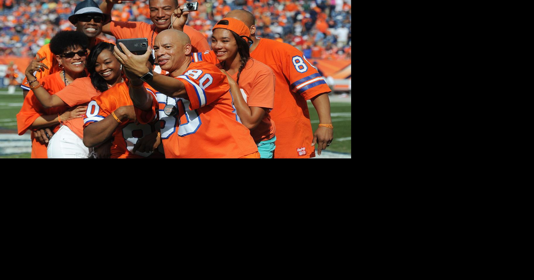 The family of Broncos great Rick Upchurch pose for a selfie (he's the one  in the hat) before his name is added to the Broncos Ring of Fame. The  Broncos beat the