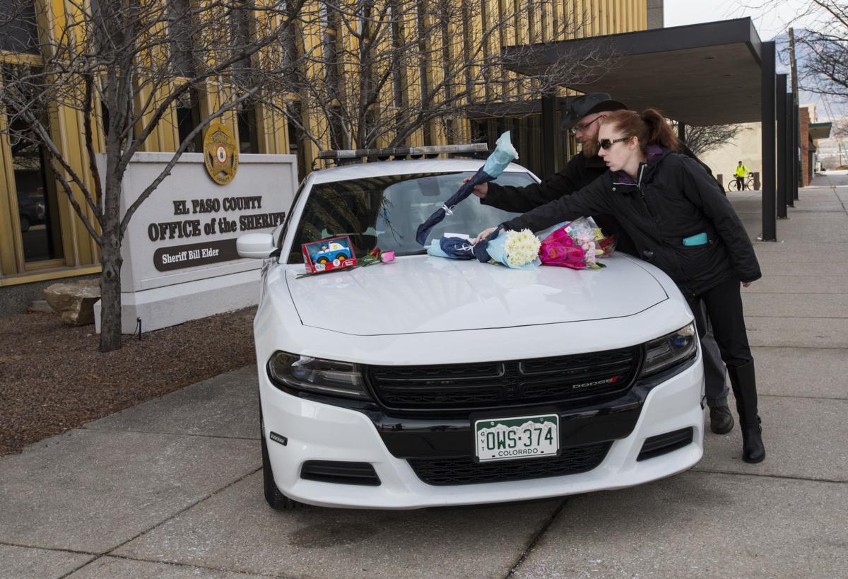 Michael Smart and Eleah Benton of Colorado Springs place flowers on a memorial outside the El Paso County Sheriffâs Office in Colorado Springs, Colo., Tuesday, Feb. 6, 2018, for deputy Micah Flick who was killed when an investigation of a motor vehicle theft turned into a deadly shooting Monday outside a Colorado Springs apartment complex. Three other law enforcement officers were shot. The suspect was killed and one citizen injured. Smart and Benton didnât know the 34-year-old deputy but wanted to pay their respects. (The Gazette, Christian Murdock)