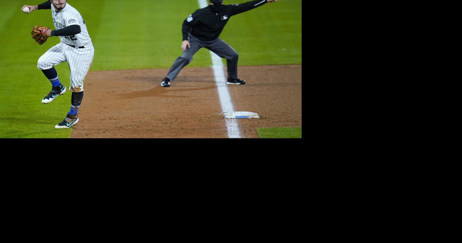 The Colorado Rockies bullpen (top) reacts as teammate Todd