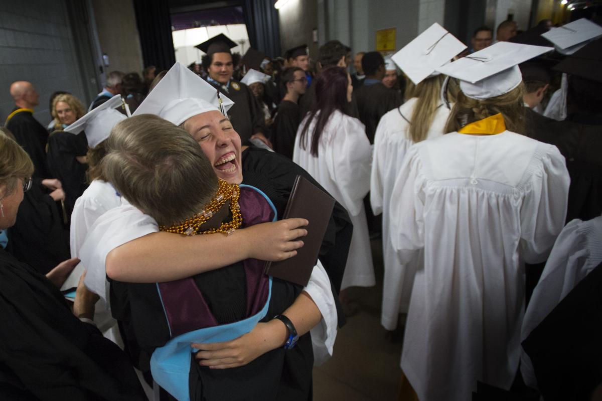 Gretchen Gaebler hugs IB coordinator Steve Kern after the Palmer Class of 2017 graduation ceremony Tuesday, May 23, 2017, at the Boardmoor World Arena in Colorado Springs. The International Baccalaureate students during the ceremony decorated Kern, who loves New Orleans, with Mardi Gras beads to show their appreciation for him. (The Gazette, Christian Murdock)