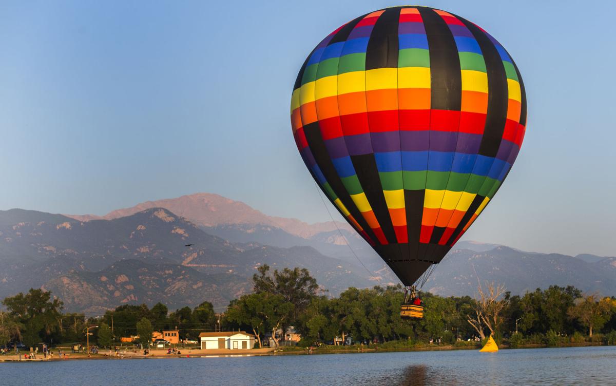 A balloon descends during a touch-and-go on Prospect Lake Saturday, Sept. 2, 2017, on the first day of the Colorado Springs Labor Day Lift Off in Memorial Park. The balloon festival runs through Monday morning. (The Gazette, Christian Murdock)