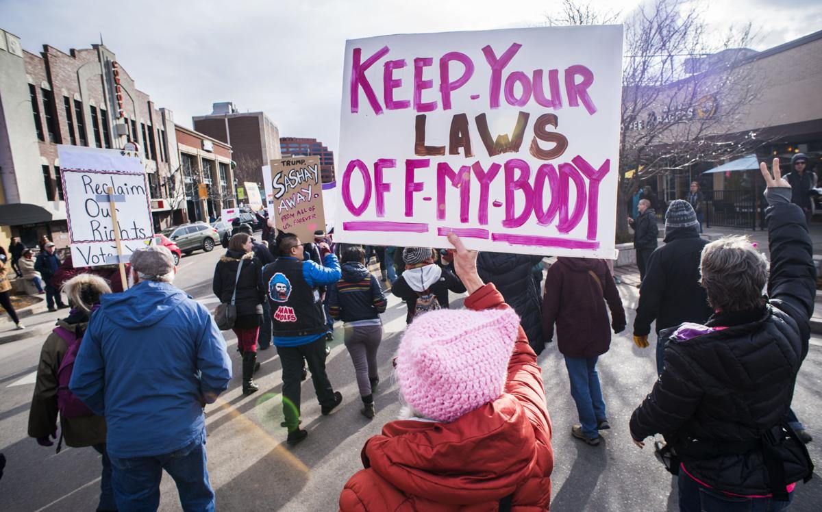 Protesters march down Tejon Street Saturday, Jan. 21, 2017, during the Colorado Springs Women's March in downtown Colorado Springs. The sister march of the Women's March on Washington, D.C., drew between 5,000 and 10,000 people. (The Gazette, Christian Murdock)