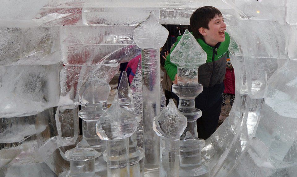 Alex Frary pokes his head through an ice sculpture at the 7th annual Cripple Creek Ice Festival on Sunday, February 16, 2014. The theme of this year's sculpting contest is Cartoons in Ice. The Ice Festival will continue next weekend.(The Gazette/Jerilee Bennett)